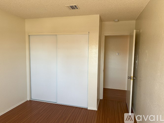 A room with a sliding door and a brown floor.