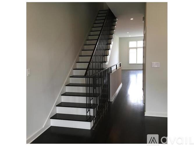 A staircase with black and white steps and railings.