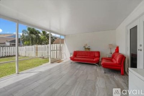 A living room with red couches and a white ceiling.
