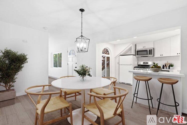 A modern kitchen with a dining table and chairs.