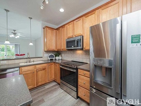 A kitchen with wooden cabinets and stainless steel appliances.