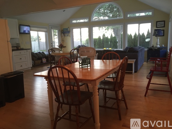 A dining room with a wooden table and chairs.