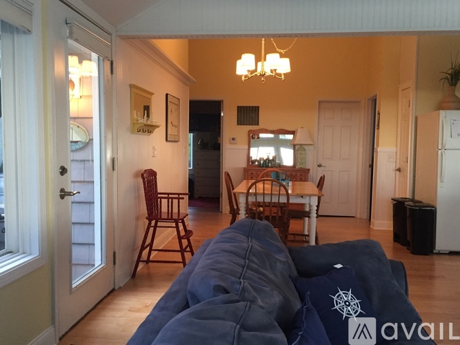 A living room with a couch and a dining table.