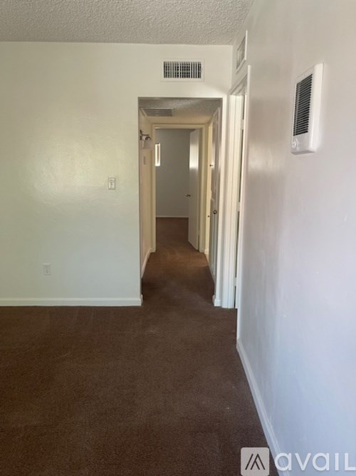 A long hallway with a door at the end.