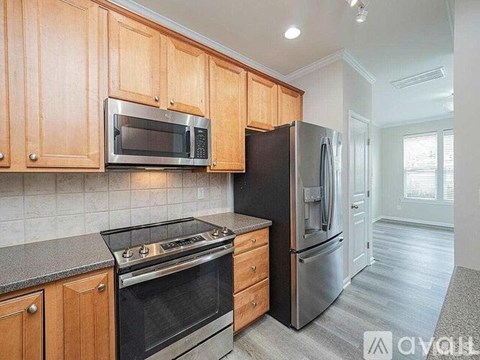 A kitchen with wooden cabinets and stainless steel appliances.