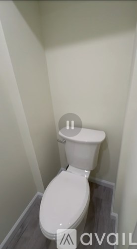 A white toilet in a small bathroom.