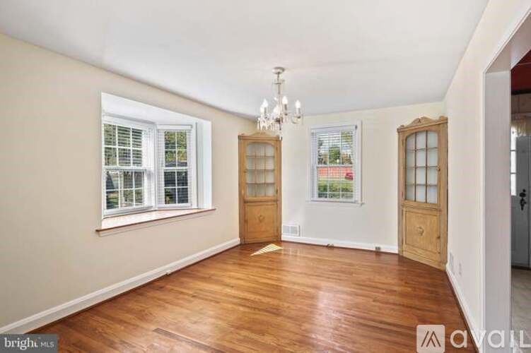 A room with wooden floors and a chandelier.