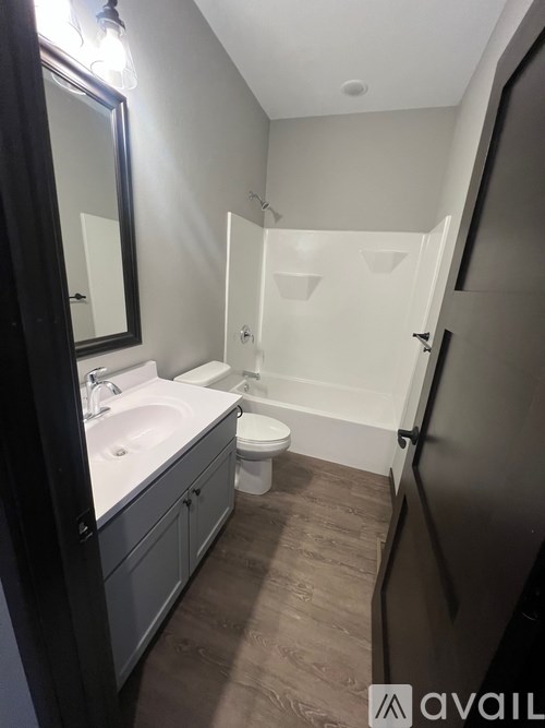 A bathroom with a sink, toilet, and shower.