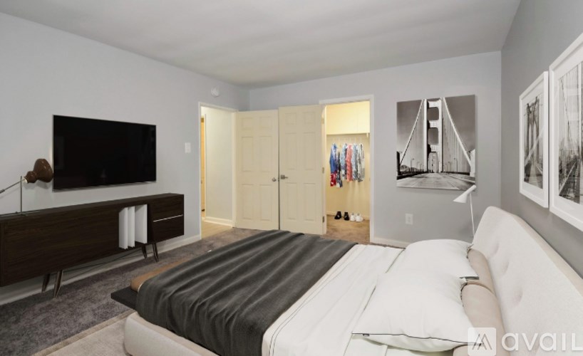 A bedroom with a large bed and a flat screen TV.