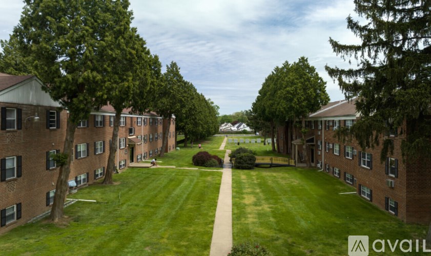 A grassy area in front of apartment buildings.