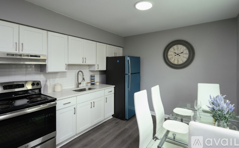 A kitchen with white cabinets and a black stove top.