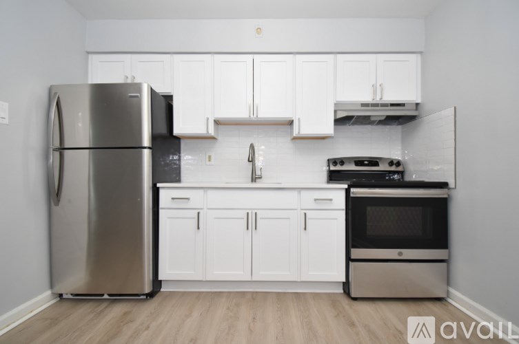 A kitchen with white cabinets and stainless steel appliances.