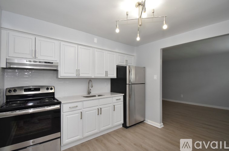 A kitchen with white cabinets and stainless steel appliances.
