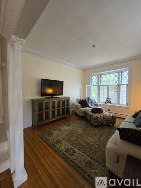 A living room with a television and a couch.