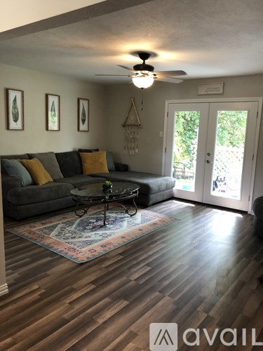 A living room with a grey couch and a coffee table.