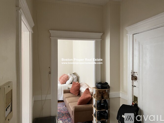 A living room with a couch and a window.