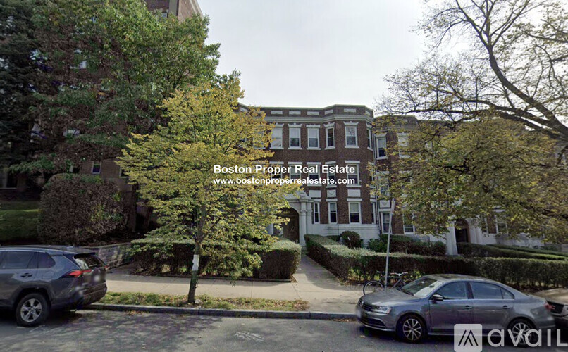 A street view with a car and a building with a sign that says Boston Proper Real Estate.