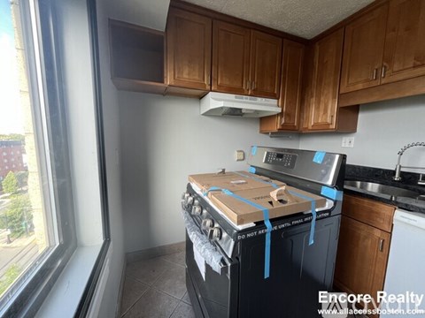 A kitchen with a stove and cabinets.