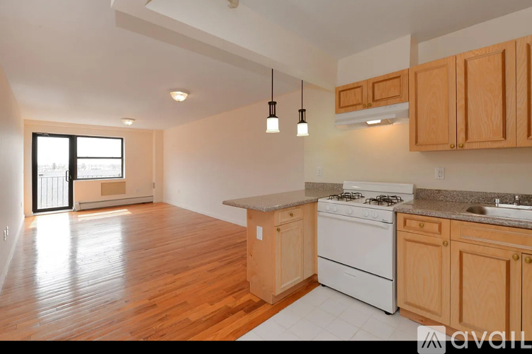 A kitchen with wooden cabinets and a white stove top oven.