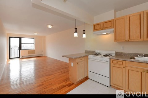 A kitchen with wooden cabinets and a white stove top oven.