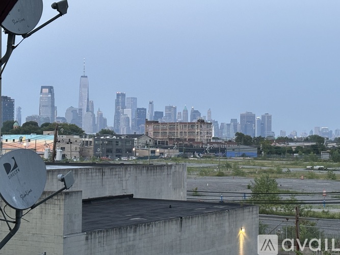 A city skyline is visible in the distance behind a parking lot.