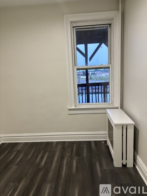 A room with a window and a bench.