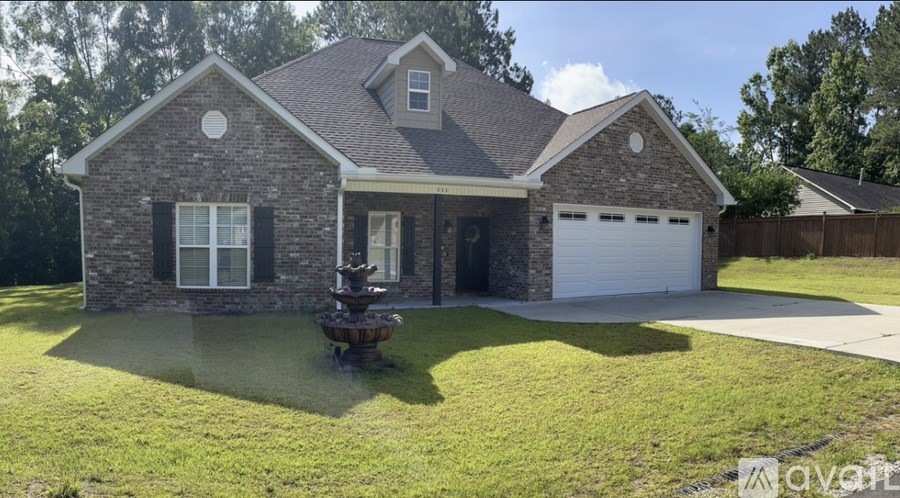 A house with a stone exterior and a white garage door.