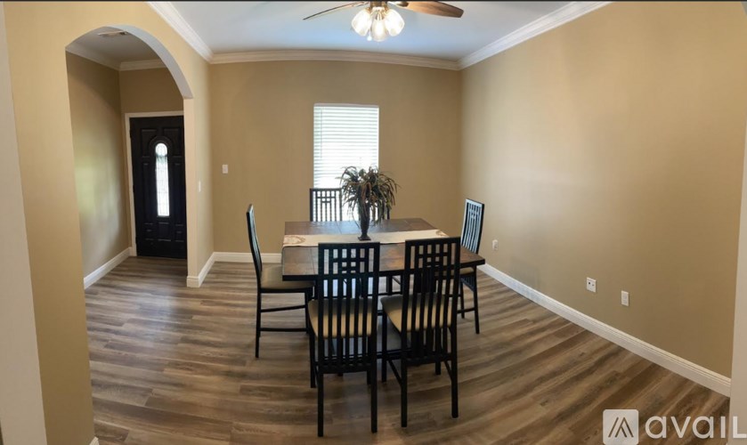 A dining room with a table set for four.