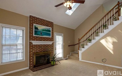 A living room with a fireplace and a painting on the wall.