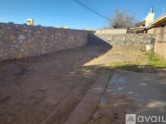 A bathroom with a sink, toilet and mirror.