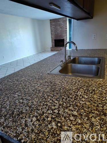 A parking lot with cars and a building in the background.