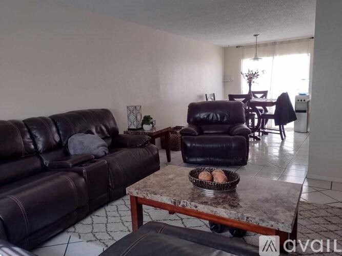 A house with a stone wall and a chimney.