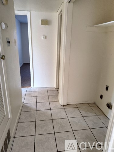 A kitchen with a white stove and wooden cabinets.