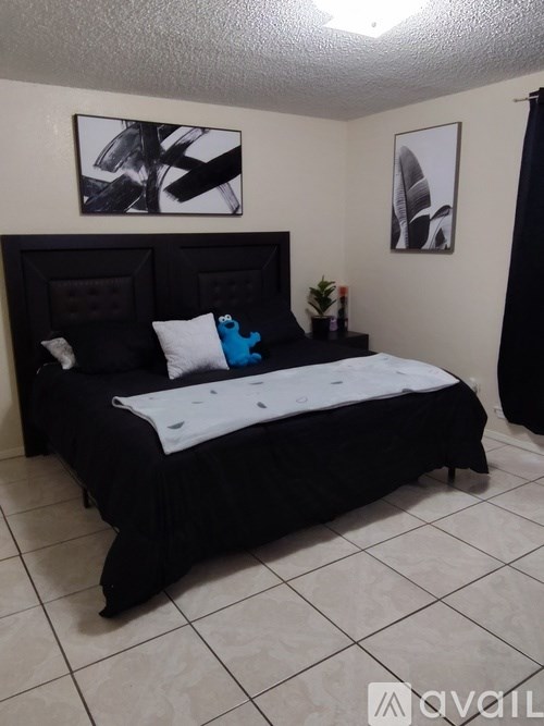 A backyard with a stone wall and a tree.