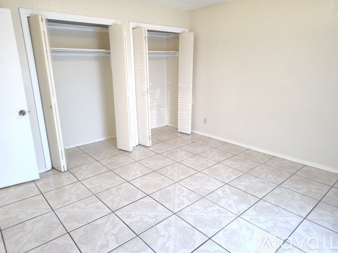A living room with a brown couch and a staircase.