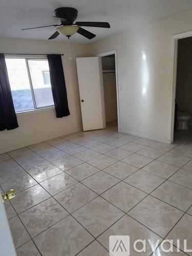A white toilet sits next to a bathtub in a bathroom.