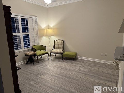 A living room with a green chair and a bench.