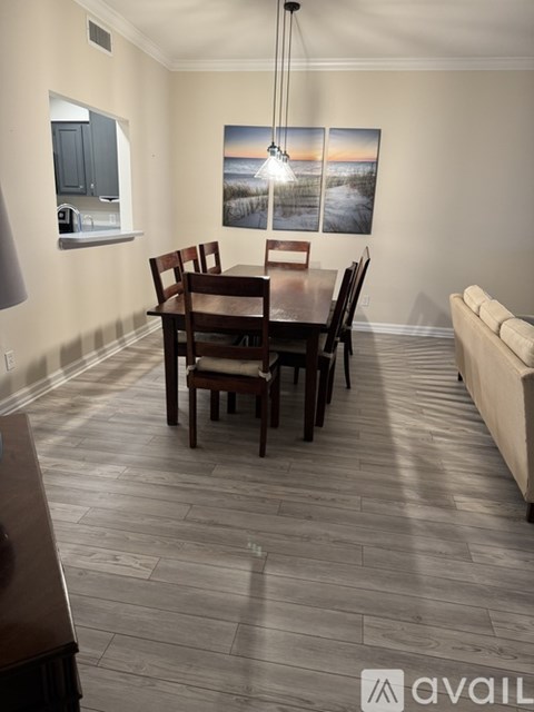 A dining room with a wooden table and chairs.
