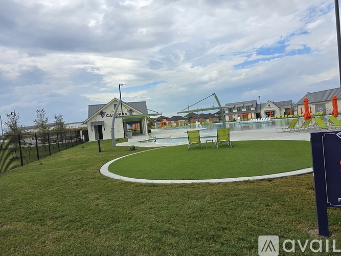 A grassy area with a building and a sign that says "AVAIL".