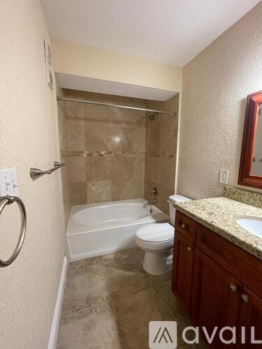 A bathroom with a toilet, sink, and shower.