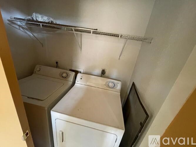 A small laundry room with a washer and dryer.