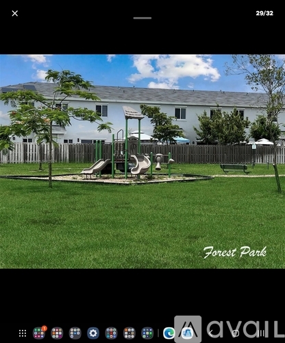 A playground in a park with a slide and swings.
