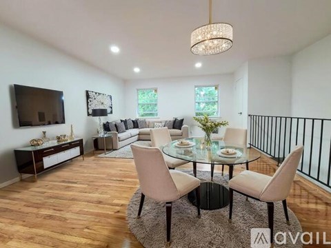 A modern living room with a glass table and chairs.