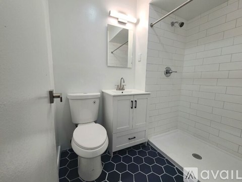 A white toilet sits next to a sink in a bathroom.