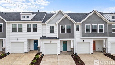 A row of houses with garages in front.