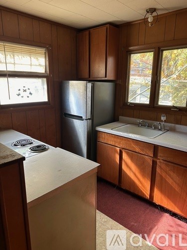 A kitchen with a refrigerator, stove, and sink.