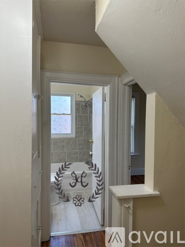 A bathroom with a white door and a white bench.