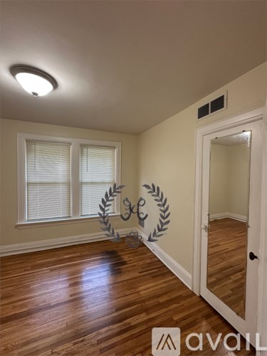 A room with wooden floors and a white door.
