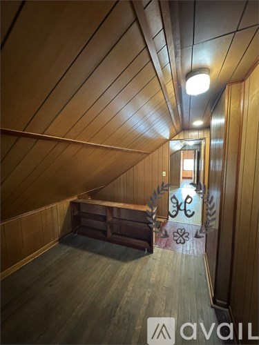 A wooden room with a long table and a bench.