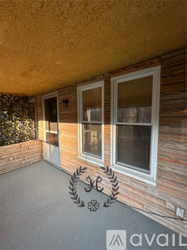 A patio area with a wall and a window.